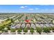 Expansive aerial view of a residential community with well-maintained homes and lush landscaping under a clear blue sky at 480 Lasso Dr, Kissimmee, FL 34747