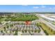 A neighborhood aerial view showcasing similar style homes and green spaces conveniently located near roadways and commercial buildings at 480 Lasso Dr, Kissimmee, FL 34747