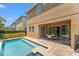 Backyard with pool, spa, patio area and manicured landscaping at 480 Lasso Dr, Kissimmee, FL 34747