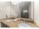 Dual vanity bathroom with granite counters, bright lighting, and separated tiled shower at 480 Lasso Dr, Kissimmee, FL 34747