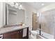 Bathroom features granite vanity, tiled shower, vanity mirror, and sink with silver faucet at 480 Lasso Dr, Kissimmee, FL 34747