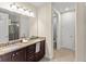 Bathroom with double granite vanity, tile flooring, and separated toilet and shower at 480 Lasso Dr, Kissimmee, FL 34747