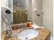Bathroom features granite vanity, mirror, overhead lighting, a hairdryer and a tiled shower at 480 Lasso Dr, Kissimmee, FL 34747