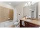 Neutral toned bathroom features a shower and tub combo, granite counters, and vanity at 480 Lasso Dr, Kissimmee, FL 34747