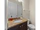 This half bathroom features granite countertops, an oval sink, and white doors at 480 Lasso Dr, Kissimmee, FL 34747