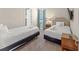 Bedroom with comfortable beds, soft carpet and natural light from a window with blue curtains at 480 Lasso Dr, Kissimmee, FL 34747