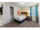 Bedroom features a queen size bed, soft carpet, closet, and natural light from a window at 480 Lasso Dr, Kissimmee, FL 34747