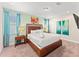 Cozy bedroom with carpet and en-suite bathroom features a large king size bed and colorful decor at 480 Lasso Dr, Kissimmee, FL 34747