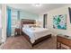 Bedroom features a queen size bed, closet, and a colorful painting on the wall at 480 Lasso Dr, Kissimmee, FL 34747