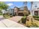 Attractive two-story home featuring a brick-paved driveway, manicured landscaping, and a two-car garage at 480 Lasso Dr, Kissimmee, FL 34747