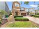 Inviting two-story home with a brick-paved driveway, well-maintained landscaping, and a two-car garage at 480 Lasso Dr, Kissimmee, FL 34747