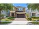 Beautiful two-story home showcasing a brick-paved driveway, and a two-car garage at 480 Lasso Dr, Kissimmee, FL 34747