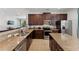 Well-equipped kitchen featuring granite countertops, stainless steel appliances, and dark wood cabinets at 480 Lasso Dr, Kissimmee, FL 34747