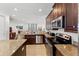 This modern kitchen has granite countertops, stainless steel appliances, and beautiful dark cabinetry at 480 Lasso Dr, Kissimmee, FL 34747