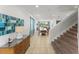 Open-concept living area with tile flooring, a dining area, and a staircase at 480 Lasso Dr, Kissimmee, FL 34747
