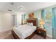 The primary bedroom features a king bed, bedside lamps, and neutral paint at 480 Lasso Dr, Kissimmee, FL 34747