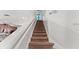 Carpeted staircase with white walls leads to the upper level of the home at 480 Lasso Dr, Kissimmee, FL 34747