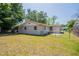 Spacious backyard with a partial fence, and mature trees offering shade at 4827 Elese St, Orlando, FL 32811