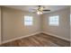 This bedroom features neutral paint, two windows with blinds, and vinyl flooring at 4827 Elese St, Orlando, FL 32811