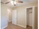 This bedroom features vinyl flooring, neutral paint and a walk-in closet at 4827 Elese St, Orlando, FL 32811