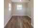 This bedroom features windows and vinyl flooring at 4827 Elese St, Orlando, FL 32811