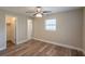 This bedroom features neutral paint, a window with blinds, and vinyl flooring at 4827 Elese St, Orlando, FL 32811
