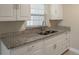 Modern kitchen with granite countertops, stainless steel sink, and stylish fixtures at 4827 Elese St, Orlando, FL 32811