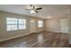 Inviting living room with wood floors, ceiling fan, and large windows at 4827 Elese St, Orlando, FL 32811