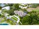 Aerial view of the property showcasing mature trees, pristine landscaping, circular drive and screened-in pool at 5025 Down Point Ln, Windermere, FL 34786