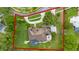 Aerial view of a large luxury home with a pool, patio, and circular driveway on a landscaped lot at 5025 Down Point Ln, Windermere, FL 34786