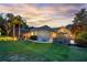 Backyard with a screened pool, stone water feature, lush landscaping, and a patio with a fire pit at 5025 Down Point Ln, Windermere, FL 34786