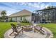 Backyard features a fire pit, pool with screened enclosure, and well-maintained lawn at 5025 Down Point Ln, Windermere, FL 34786