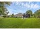Large backyard with screened-in pool and fire pit offers multiple entertainment options at 5025 Down Point Ln, Windermere, FL 34786