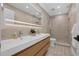 Bright bathroom with double vanity, tile floor, a large mirror and shower with glass doors at 5025 Down Point Ln, Windermere, FL 34786