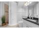 Bathroom featuring a shower with dark trim, a white toilet, white paneled walls, and a black countertop at 5025 Down Point Ln, Windermere, FL 34786