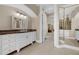 Bright bathroom with a long vanity with a brown countertop and doorway leading to the rest of the house at 5025 Down Point Ln, Windermere, FL 34786