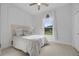 Bright bedroom with white walls and a window view, featuring a bed and clean carpet at 5025 Down Point Ln, Windermere, FL 34786