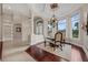 Dining room with hardwood floors, chandelier, and large windows that let in natural light at 5025 Down Point Ln, Windermere, FL 34786
