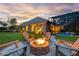Outdoor fire pit surrounded by Adirondack chairs, perfect for cozy evenings in the backyard at 5025 Down Point Ln, Windermere, FL 34786