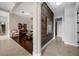 Open hallway with views to the living room, dining room, and powder room at 5025 Down Point Ln, Windermere, FL 34786
