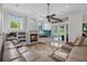 Cozy living room featuring a fireplace, plush seating, and views of the pool area at 5025 Down Point Ln, Windermere, FL 34786
