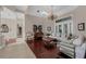 Spacious living room with hardwood floors, elegant chandelier, and large windows at 5025 Down Point Ln, Windermere, FL 34786