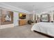 Spacious main bedroom with a large closet, TV, and seating area at 5025 Down Point Ln, Windermere, FL 34786