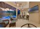 Covered outdoor kitchen and bar with chairs, ceiling fans, and sitting area by the pool at 5025 Down Point Ln, Windermere, FL 34786