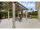 Outdoor patio with a pergola and a fireplace, perfect for outdoor entertaining in a landscaped backyard at 5025 Down Point Ln, Windermere, FL 34786