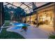 Serene pool and spa area with an outdoor kitchen, bar, and lounge space for relaxation and entertainment at 5025 Down Point Ln, Windermere, FL 34786