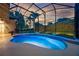Screened pool with bright blue water and landscape features offers a relaxing backyard retreat at 5025 Down Point Ln, Windermere, FL 34786