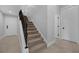 Staircase with carpeted steps and a decorative railing leading to the upper level of the house at 5025 Down Point Ln, Windermere, FL 34786