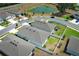 Residential community with modern homes, a pond, and well-maintained landscaping under a clear sky at 5089 Meadow Song Dr, Okahumpka, FL 34762