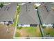 Aerial view of a modern home featuring a fenced backyard, with green lawn, and screened lanai at 5089 Meadow Song Dr, Okahumpka, FL 34762